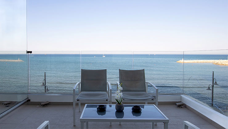 Deyar sea view property balcony furniture with chairs and tabel and the background view of the sea behind it.