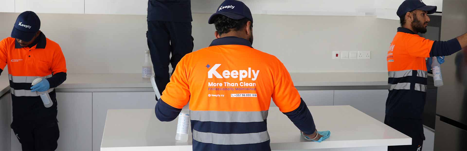 keeply staff in uniform cleaning a kitchen of a property