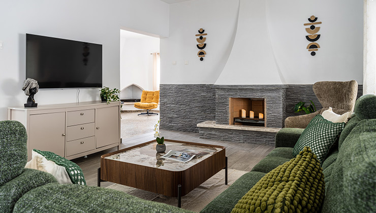 Deyar house property living room with modern furniture, tv, chair and chimney